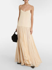 Kleid mit Trägern, tiefer Taille und unregelmäßigem Saum